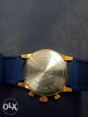 Round Gold-colored Chronograph Watch With Blue Strap