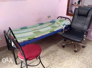Metal bed with mattress and two chairs on sale in