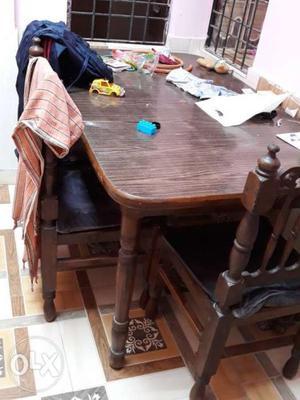Wooden dinning table with 4 chair and cussions..