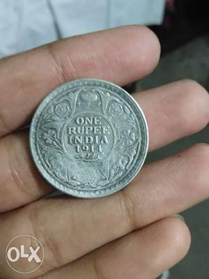 Its a silver one rupee coin tym of british