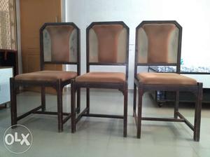 Three Brown Wooden Framed Black Leather Padded Chairs