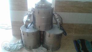 Three Cylindrical Gray Metal Containers