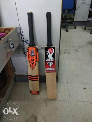 Two Brown-and-black Cricket Bats