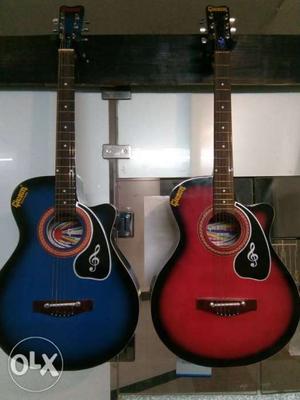 Two Red And Blue Cutaway Acoustic Guitars