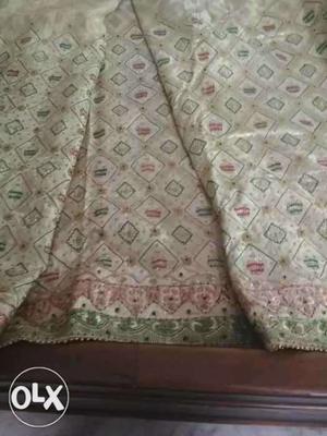 Very heavy. Bridal sari full of hand work only one time used