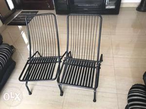 Two Black Metal Folding Chairs