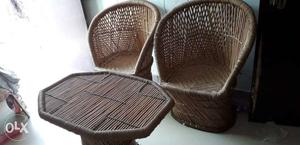 Two Brown Wicker Chairs And Table