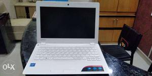 White HP Laptop With Black Wireless Mouse