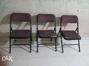 Three Maroon-and-black Folding Chairs