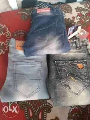 Two Pairs Of Blue And Gray Denim Bottoms