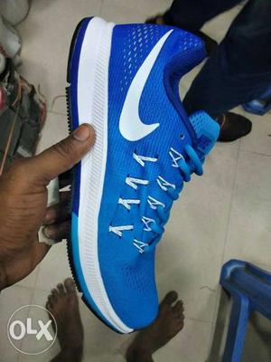 Unpaired White And Blue Nike Sneaker