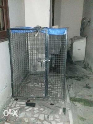 Gray Metal Pet Cage With Blue And White Plaid Textile