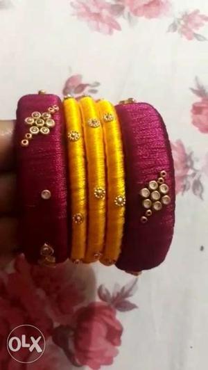 Three Yellow And Two Pink Silk Bracelets