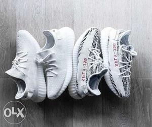 Two Pairs Of White And Black Adidas Yeezy Boost 350 V2's