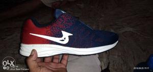 Unpaired Blue, White, And Red Low-top Running Shoe