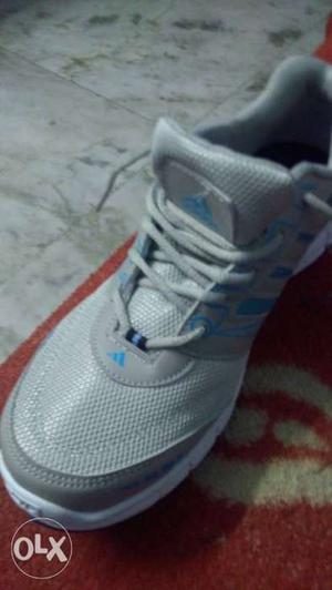 Unpaired White Adidas Running Shoe