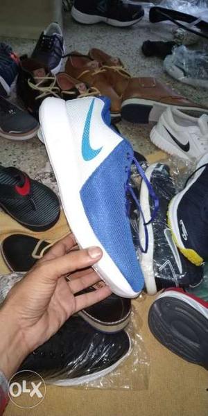 Unpaired White And Blue Nike Shoe
