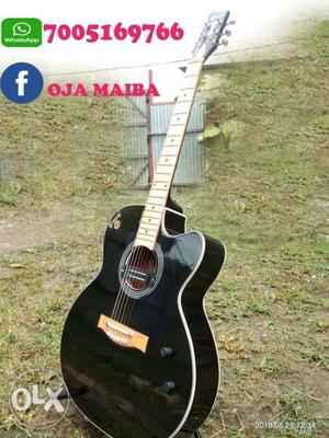 Black And Brown Acoustic Guitar With Text Overlay