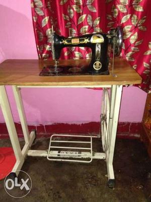 Black, Brown, And White Treadle Sewing Machine