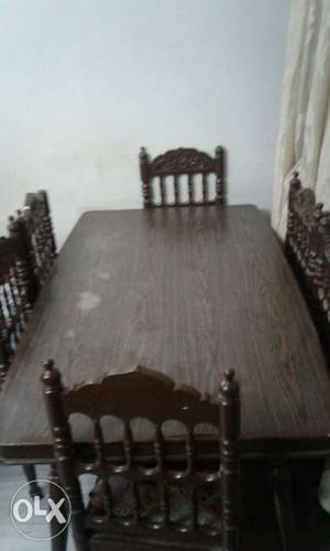 Dark brown color dining table set.each chair has