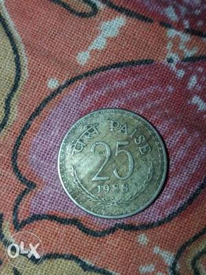 Round  Gold-colored 25 Indian Paise Coin