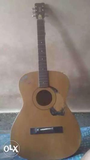 Guitar with strings and little bit crack on neck