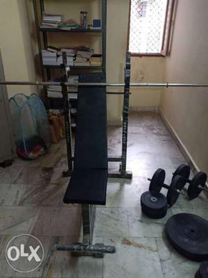 Gym bench with rod and weights.. total weight