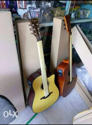Two Beige And Brown Cutaway Acoustic Guitar