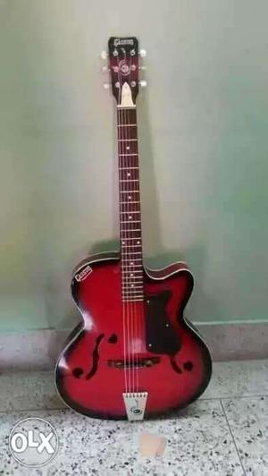 Red Gibson Acoustic Guitar