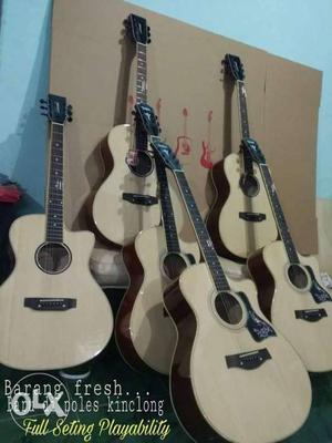 Six Brown Cutaway Acoustic Guitars
