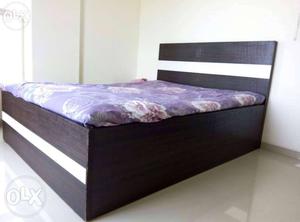 Black Wooden Bed Frame With Purple Mattress