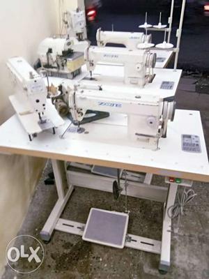 Four White Sewing Machines