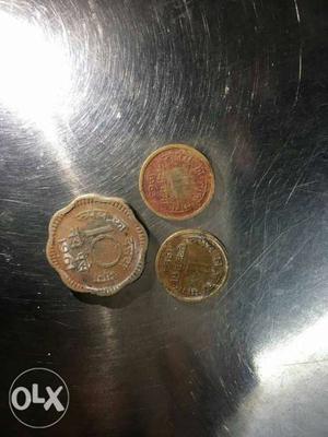Two 1 Rupee coins made with copper and a 10 paisa
