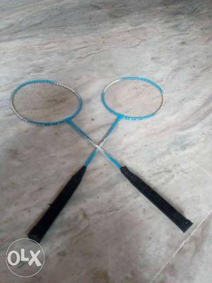 Two Teal Badminton Rackets