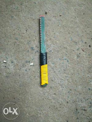 Yellow, Black, And Green Hand Tool