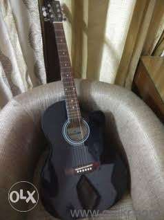 Black acoustic guitar first handed