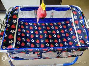 Blue color baby cradle with swing.