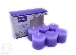 Several Purple Pillar Candles With Box