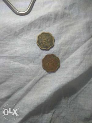 Two Scalloped Edge Gold-colored 10 Indian Paise Coins