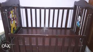 Wooden cot with safe gaurds on both sides and