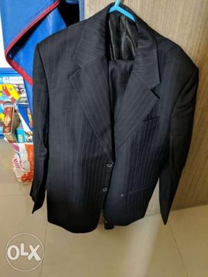 Black 2 piece suit with purple strips.Almost new.