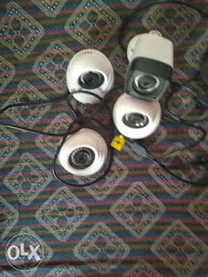 Four White-and-black Surveillance Cameras