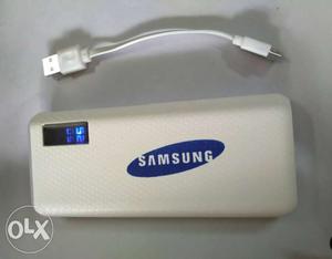 Gray Samsung Power Bank And White USB Cable