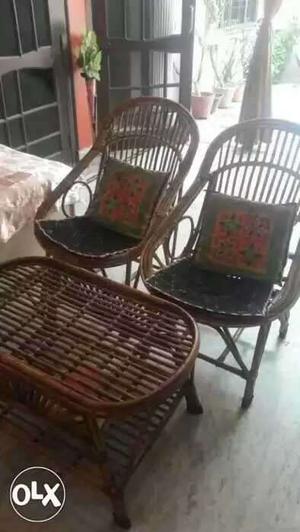 Tow cane chairs and table in good condition