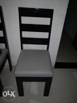 Black Wooden Framed White Padded Chair