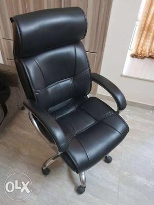 Black revolving leatherette office chair. A few minor cuts.