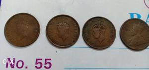 Four Round Copper-colored British Indian Coins