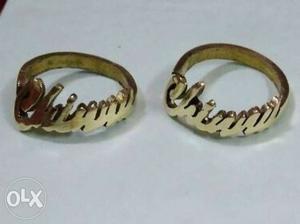 Pair Of Gold-colored customised Rings and keychains