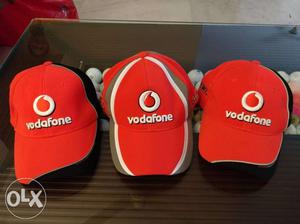 Three Red-and-black Vodafone Fitted Caps