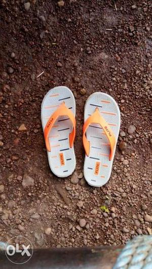 Pair Of White-and-orange Flip Flops